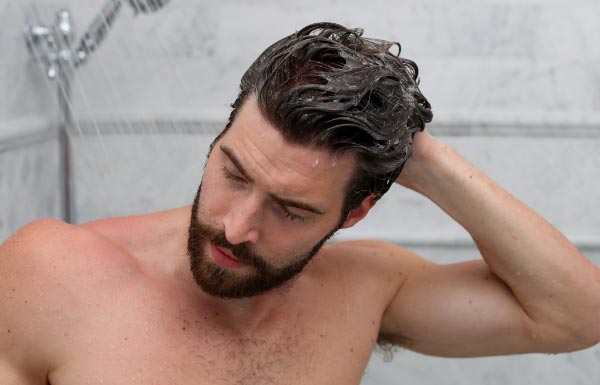 A man washing his hair with the ProLuxe Hair Care System.